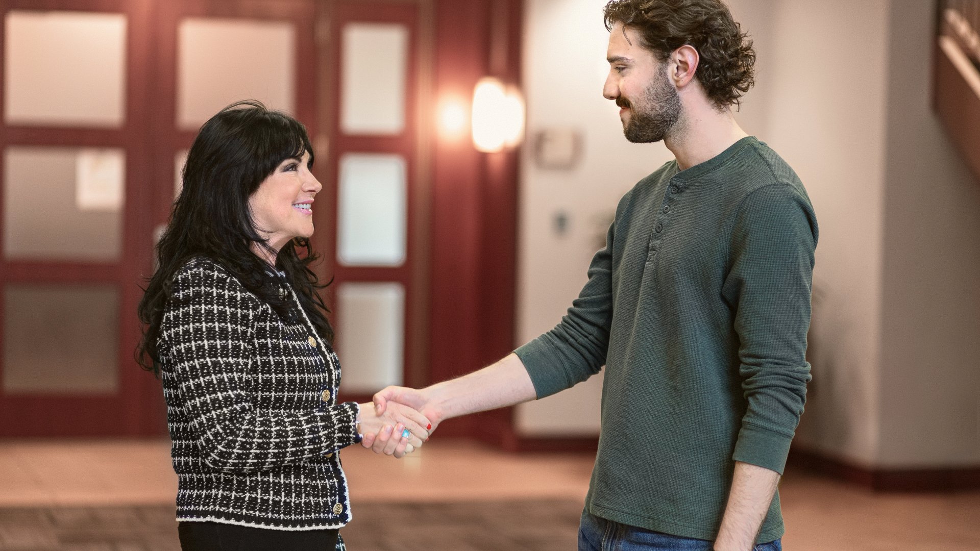 Attorney Paula Robinson shaking hands with a client in a courthouse hallway.